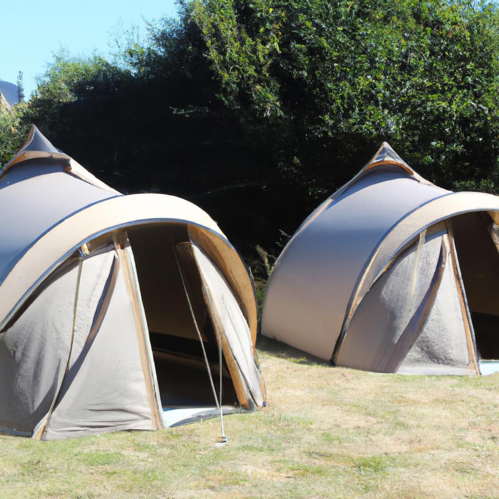 Tent pitched in the woods with a roaring campfire nearby. Folded chairs and a cooler sit outside the tent. Stars twinkle in the night sky above. A peaceful camping site deep in the wilderness.