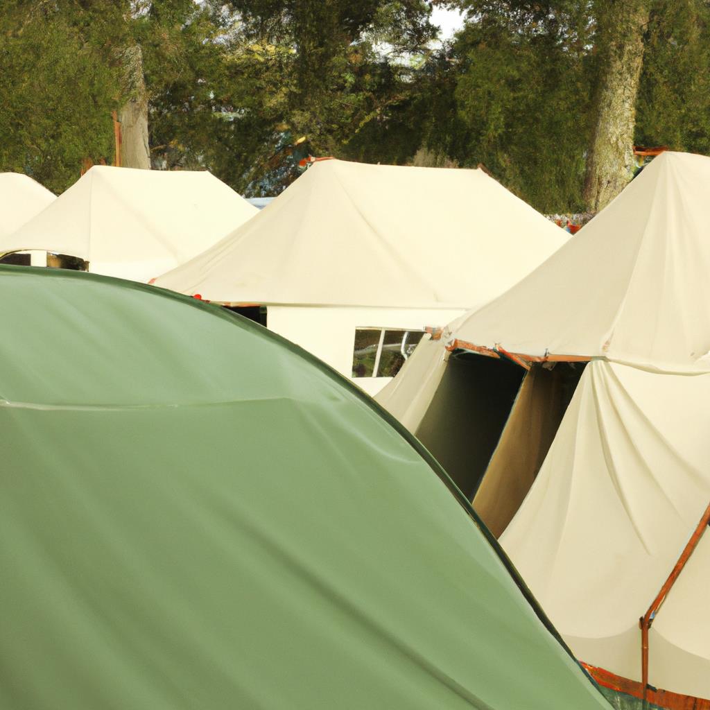 A serene camping site with tents set up among tall trees. A flowing river can be seen in the background, with mountains in the distance. The site is surrounded by lush greenery, creating the ideal getaway for outdoor enthusiasts.